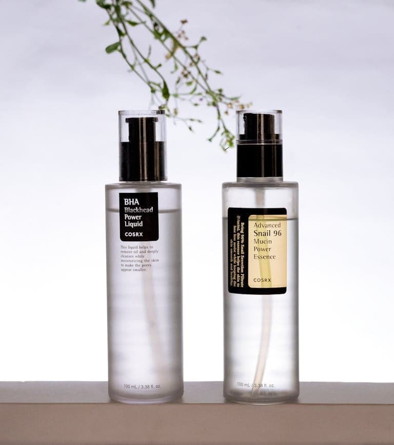 Minimalist photo of cosmetic serum bottles on a white background.