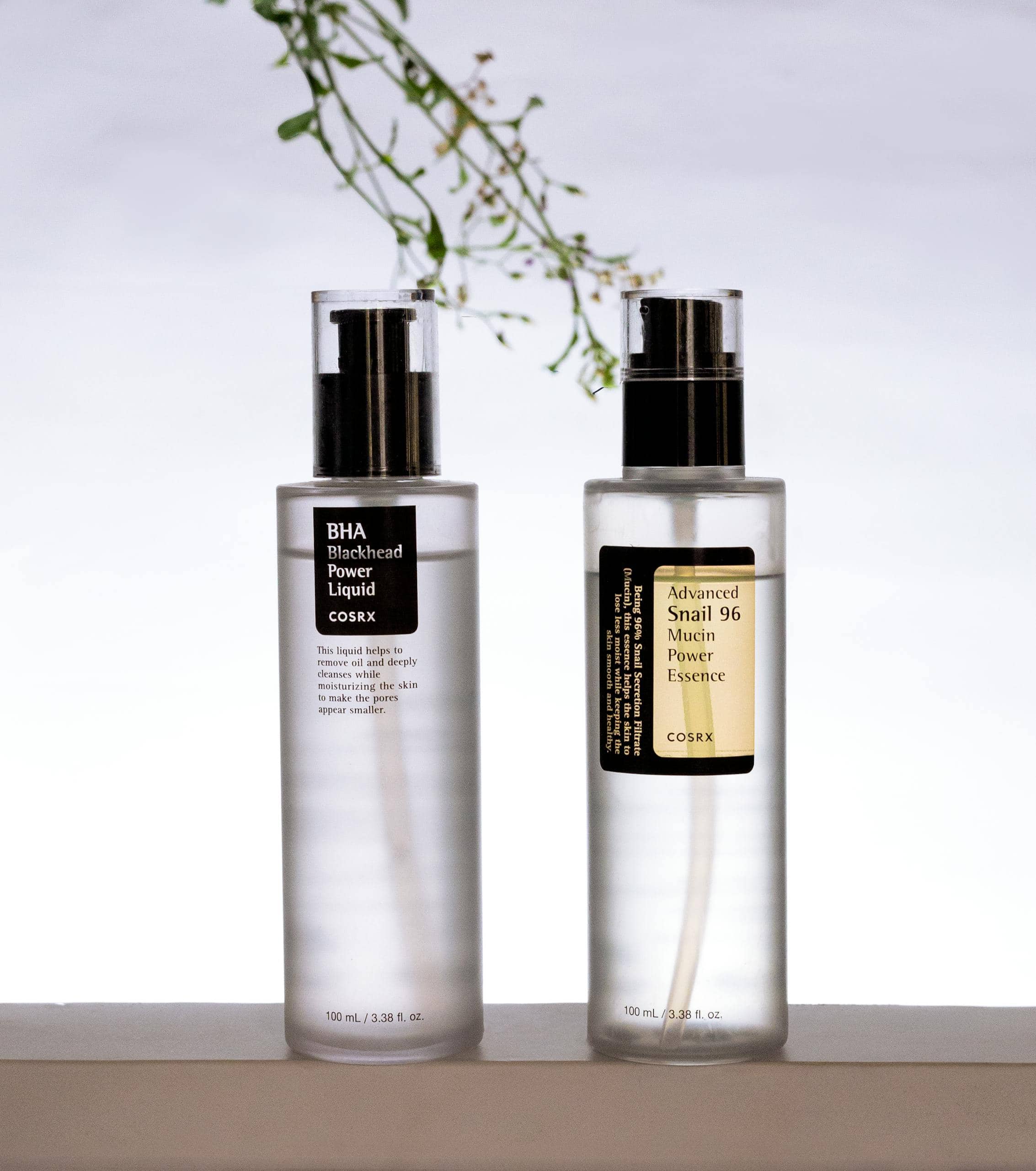 Minimalist photo of cosmetic serum bottles on a white background.