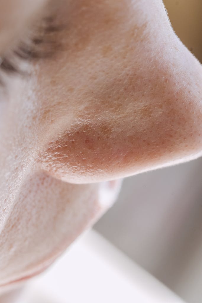 Detailed close-up of a human nose highlighting pores and skin texture, showcasing natural beauty.